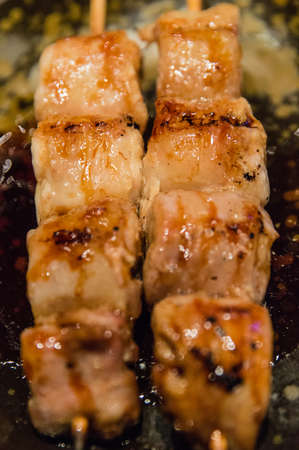 chicken Yakitori on skewers served with yakitori sauceの写真素材