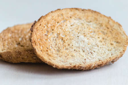macro of two slices of wholemeal toast isolatedの写真素材