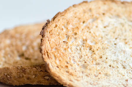 Macro of two slices of wholemeal toast isolatedの写真素材