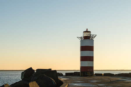 Lighthouse at the end of the pierの写真素材