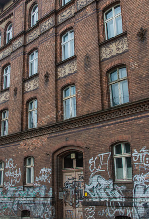 Dirty brick buildingl with traces of old graffitiのeditorial素材