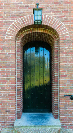 Door of an church of the dutch village of pieterburenの写真素材