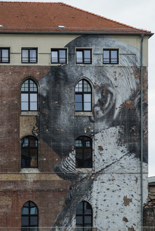 Berlin, Germany - August 30, 2014: Mural from project Wrinkles of the city by artist JR at Postbahnhof in Berlinのeditorial素材