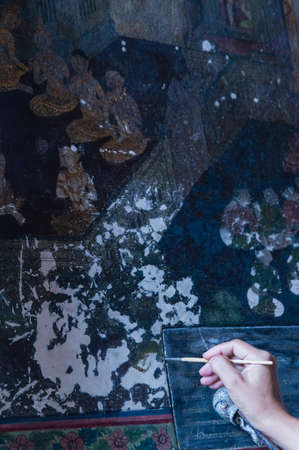 Artist Restoring a Painting