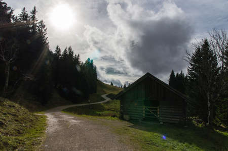 Wooden cabin in the Alps with hiking pathの写真素材