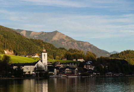 View of View of St. Wolfgang chapel and the village waterfront at Wolfgangsee lake, Austriaのeditorial素材