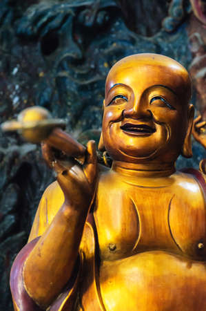 Detail of A Happy Monk on Guanyin, a manifestation of the Bodhisattva Avalokite?vara, with relief screen, at the back of the Grand Hall of the Great Sage.Lingyin Temple, Hangzhou, Shandong Province, Chinaの写真素材