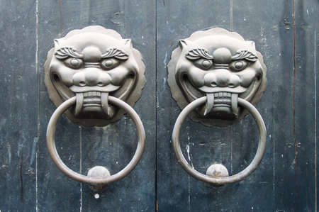 traditional Chinese door knocker on a Green Doorの写真素材