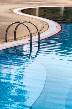 Curved side of a swimming pool with stairs.のeditorial素材