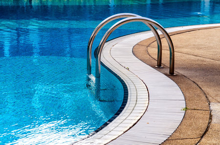 Curved side of a swimming pool with stairs.のeditorial素材