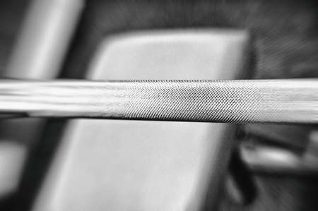 Gym equipment background with close up selective focus to a lifting barの写真素材
