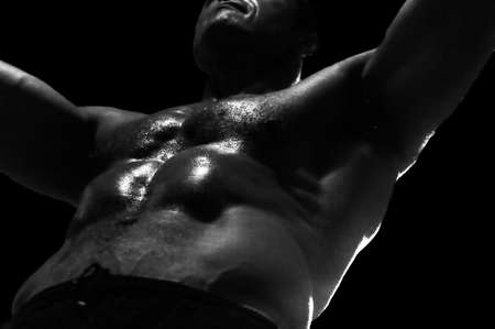 Low-key image of muscular masculine manの写真素材