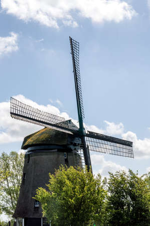 Traditional windmills in dutch landscape in the Netherlandsの写真素材