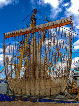 Fishing nets hanging from a trawler to dryの写真素材