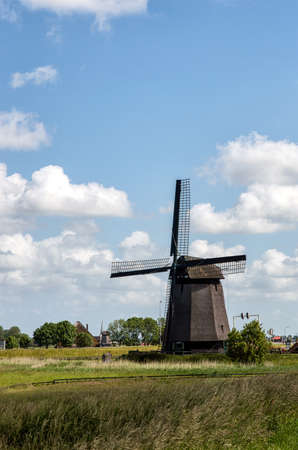Traditional windmills in dutch landscape in the Netherlandsの写真素材
