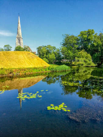 St. Alban's Church is located in Churchill Park, or Parken if you're Danish, and rises over the canal and levee of the parkの写真素材