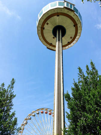 View Tower at an amusement park and ferris wheel in the backgroundの写真素材