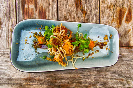 Tempura Crab with mini dumplings on a bed of oriental vegetablesの写真素材