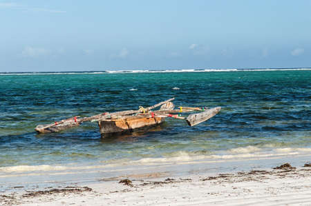 A dhow moored on the beach in Zanzibar, Tanzaniaの写真素材