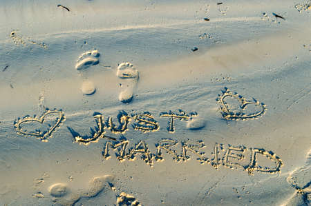 "Just Married" written in the sandの写真素材