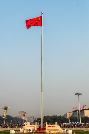 Beijing, China - October 4th 2015 The Chinese flag flies proudly in Tiananmen Square whilst tourist mill about taking photographsのeditorial素材