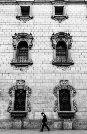 A Man walking in front of Colonial Building in Lima, Peruのeditorial素材