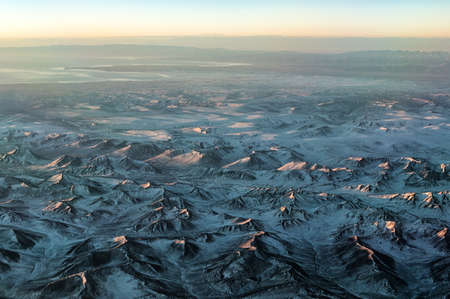 Sunrise as seen from Cockpit Window over Mountain range at Sichuan Areaの写真素材