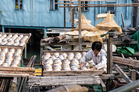 Hong Kong - November 30, 2015: Fish sellers weighing and selling fresh fish. Located in Tai O of Hong Kong.のeditorial素材