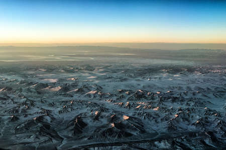 Sunrise as seen from Cockpit Window over Mountain range at Sichuan Areaの写真素材