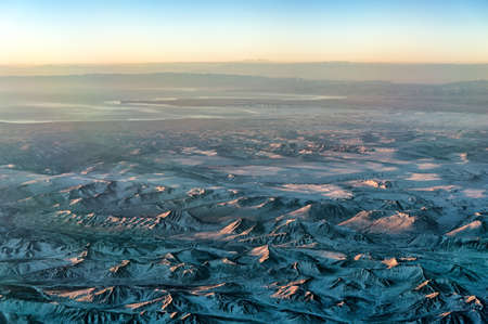 Sunrise as seen from Cockpit Window over Mountain range at Sichuan Areaの写真素材