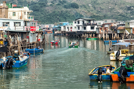 Hong Kong, China - November 30, 2015: Houses on stilts above the tidal flats of Lantau Island are homes to the Tanka people in Tai O, Hong Kong. These unusual structures are interconnected, forming a tightly knit fishing community that literally lives on のeditorial素材