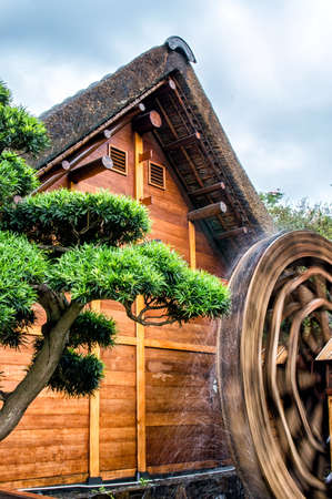 A water wheel consists of a large wooden wheel.の写真素材