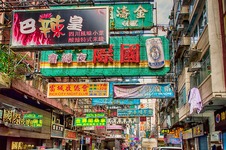 Busy street with advertising signs and buses in Kowloon Peninsula district in Hong Kong. The City is known worldwide for its colorful signs.のeditorial素材
