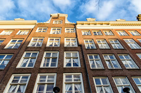 The facades of a row of beautiful Amsterdam canal houses.