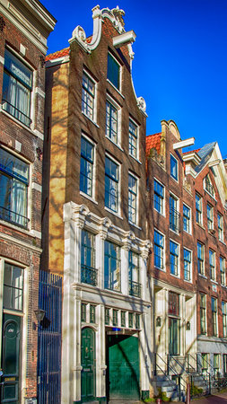 Traditional dutch buildings on canal in Amsterdamのeditorial素材
