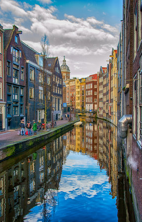 Amsterdam City Scene. Visible are many typical dutch houses in raw and their reflection in the canal. Old 17th and 18th century brick houses along a canal in center of Amsterdam, Netherlands.のeditorial素材
