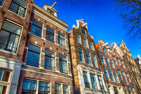 Traditional dutch buildings on canal in Amsterdamの写真素材