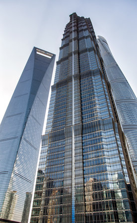 Looking up at the Jin Mao Tower, the Shanghai World Financial Center, and the Shanghai Towerのeditorial素材