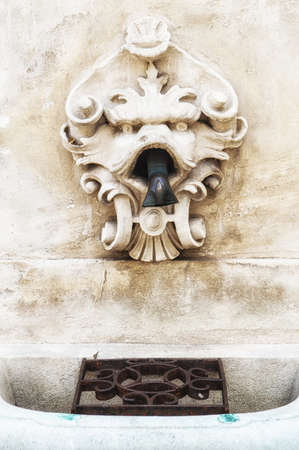 Close view of an old European-style public water faucet found around Vienna.の写真素材