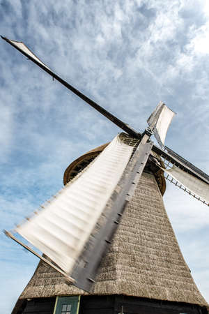 A Dutch windmill close-up against a blue sky.の写真素材