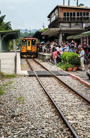 Shifen, Taiwan - July 24, 2016: An old train is going through the Shifen Village near Taipei, Taiwan. People can be seen walking along the tracksのeditorial素材