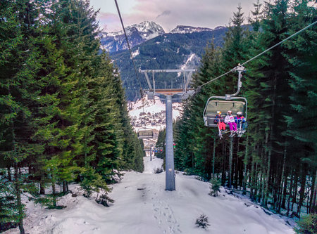 Gosau, Austria - March 2, 2017: The Alpine Mountains of the Dachstein mountain Range are a well known alpine excursion destination in Austria. People enjoy their winter holidays using the chair lift.のeditorial素材