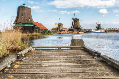 Zaanse Schans, the Netherlands - April 19, 2017: windmills at Zaanse Schans, an industrial and national Dutch heritage site and famous tourist destination in the municipality of Zaandam, the Netherlands. Zaanse Schans is located on the river Zaan, from whの写真素材