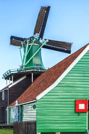 Traditional Dutch old wooden windmill in Zaanse Schans - museum village in Zaandam, The Netherlands.の写真素材