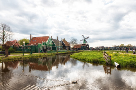 Amsterdam, Netherlands - April 19, 2017 : Scene of Dutch village with Windmill and bridge, Nice travel destination in Zaanse Schans.のeditorial素材