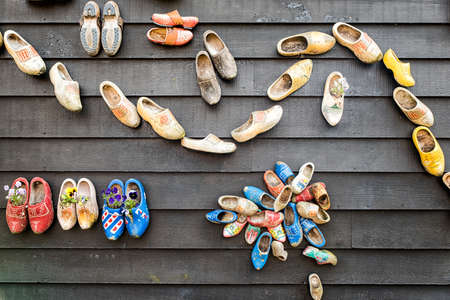 Traditional dutch wooden shoes hanging on a wall as decorationの写真素材