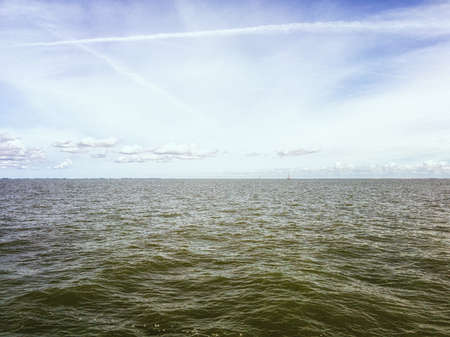 Seascape view of the Ijsselmeer, the Netherlands with in the distance Sailing ships.の写真素材