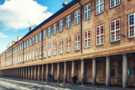 ?openhagen, Denmark - September 20, 2017: Sunlit colonnade outside the Danish National Museum in central Copenhagen. Pedestrians and other traffic at the end of the colonnade.のeditorial素材