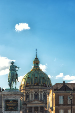 Frederik V of Denmark statue at  Copenhagen's Amalienborg or Royal Palace courtyard with dome of Marble church (Frederik's Church) behind in Copenhagen, Denmarkのeditorial素材