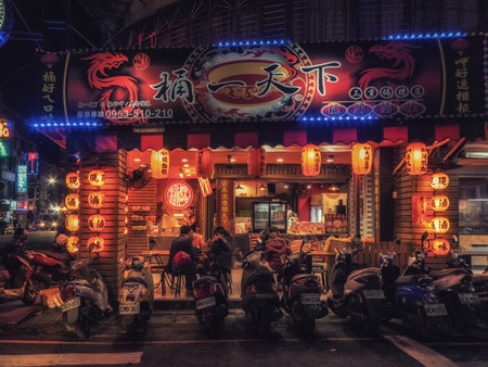 Taipei, Taiwan - February 28, 2018: Pavement cafe serving Taiwanese fast food to locals illuminated at night in the downtown district of Taipei.のeditorial素材